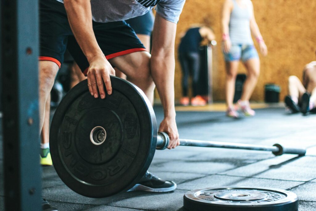 loading weights on the bar to perform exercise