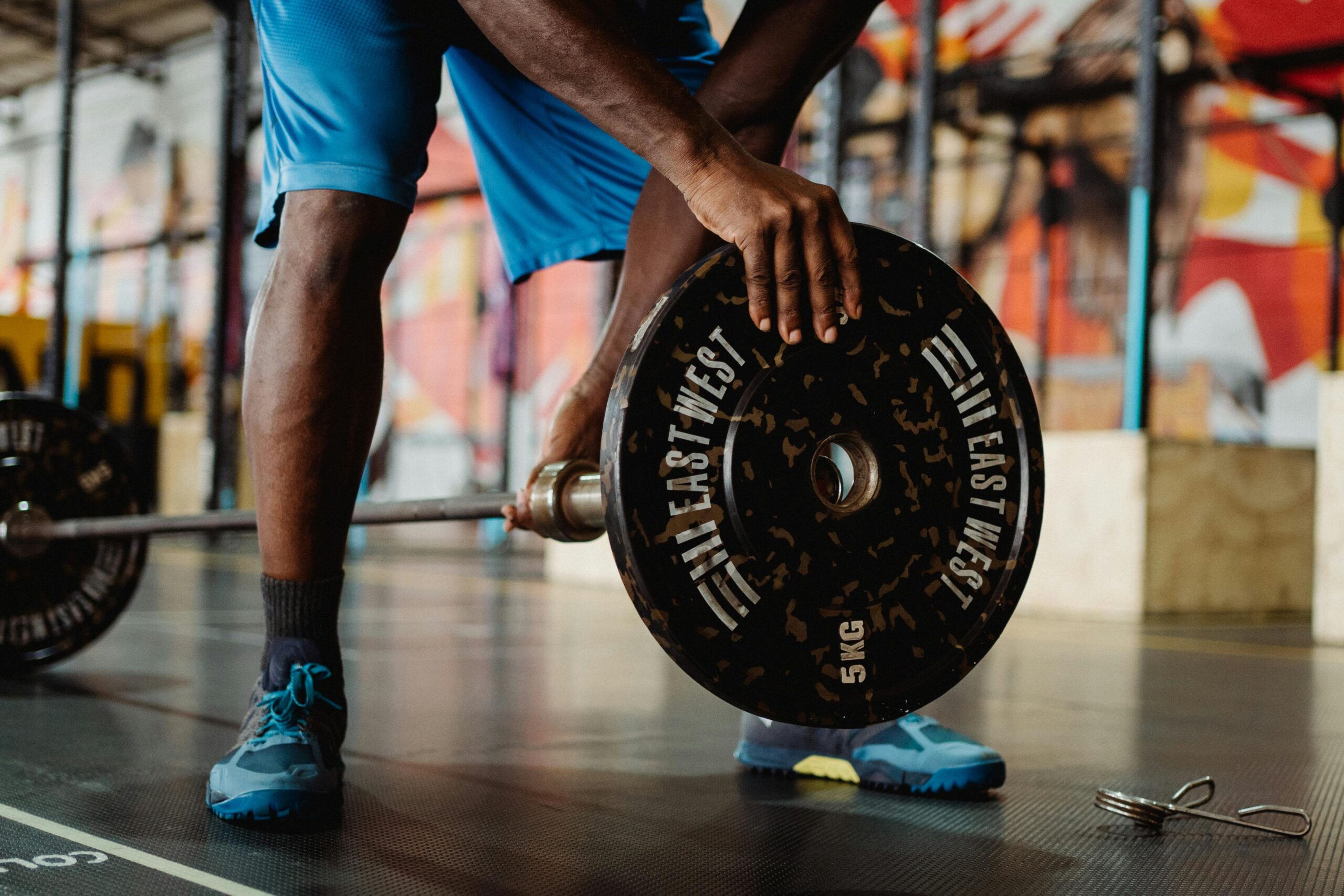 A person loading weights on the barbell