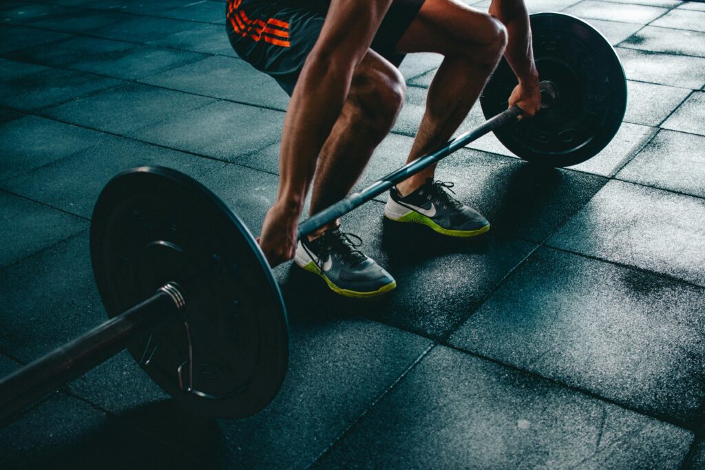 a man performing deadlift in a gym