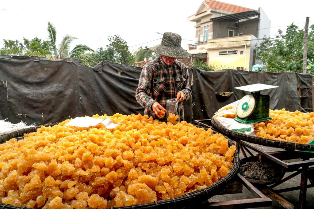 a man selling jaggery on his cart