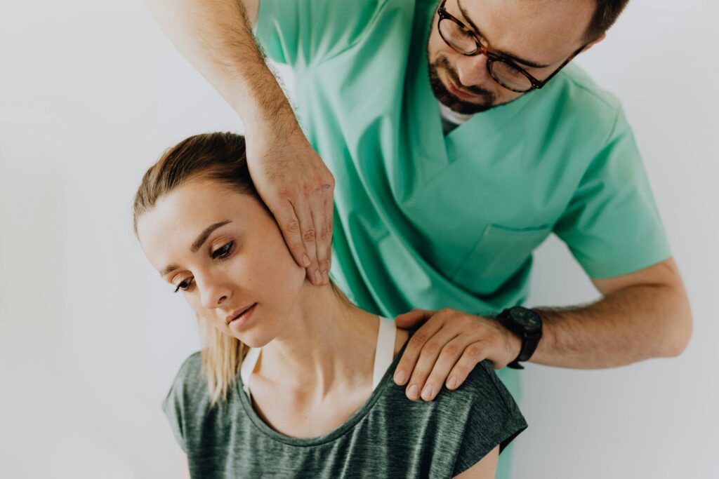 Doctor trying to help his patient in fixing her shoulder pain