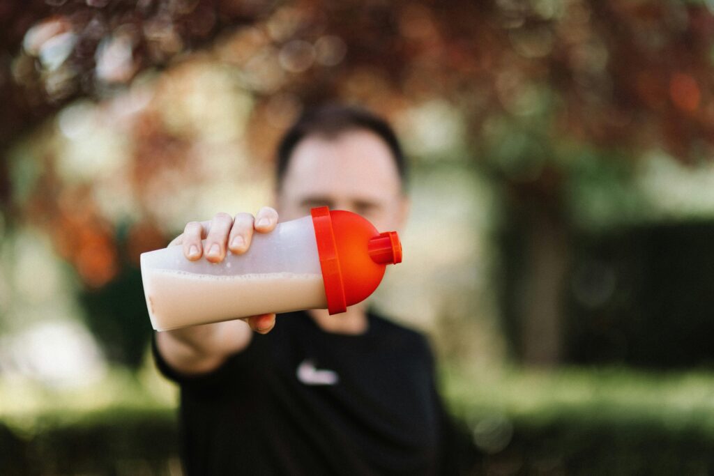 person holding his nutrition supplement